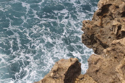 High angle view of rock formation in sea