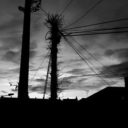 Low angle view of electricity pylon against sky