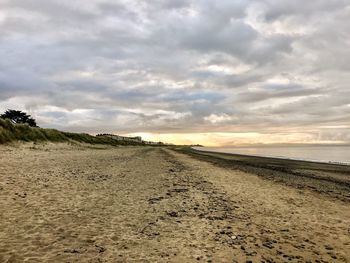 Scenic view of beach against sky during sunset