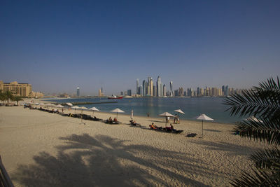 Panoramic view of beach against clear blue sky