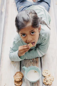 High angle view of girl eating breakfast on table