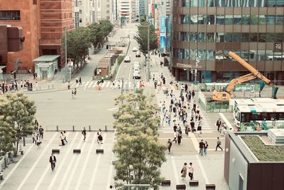 High angle view of people walking on road amidst buildings