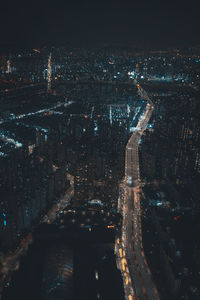 Aerial view of illuminated city buildings at night