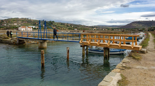 Pier over river against sky