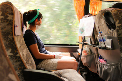 Young woman sitting in bus