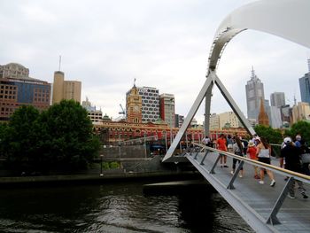 Bridge over river with buildings in background