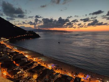 High angle view of sea against sky at sunset