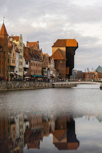 Ancient crane - zuraw old town in gdansk. the riverside on granary island reflection in moltawa