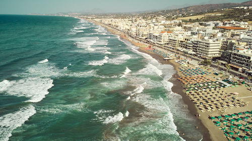 High angle view of sea and buildings in city