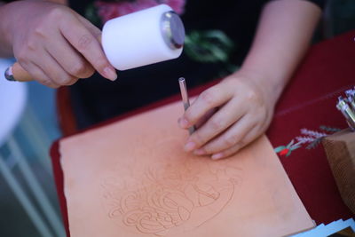 Close-up of hand holding paper