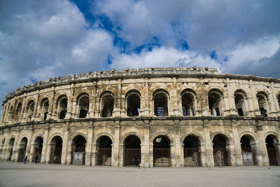 Low angle view of historical building against cloudy sky