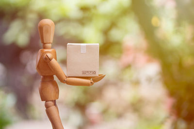 Midsection of person holding paper against blurred background