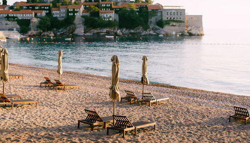Chairs on beach by sea