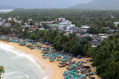 High angle view of boats moored at beach by trees