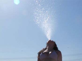 Low angle view of woman against sky