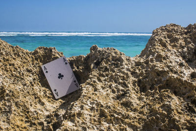 Scenic view of rocks on beach against sky