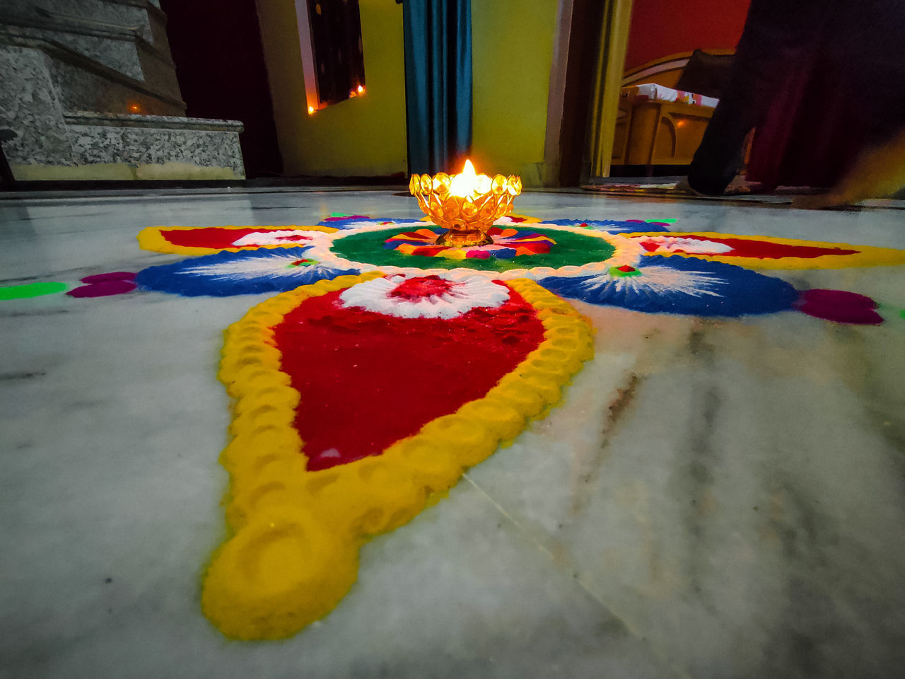 CLOSE-UP OF MULTI COLORED BURNING CANDLES ON YELLOW