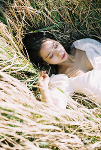 Portrait of woman lying down on grass