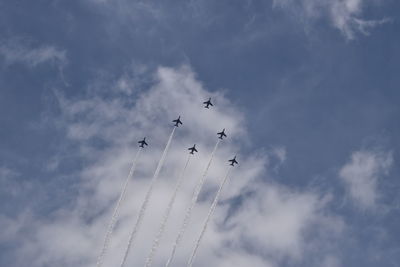 Low angle view of airshow against sky