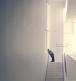 Man standing in illuminated corridor