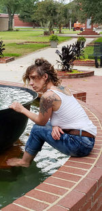 Full length of woman sitting in park