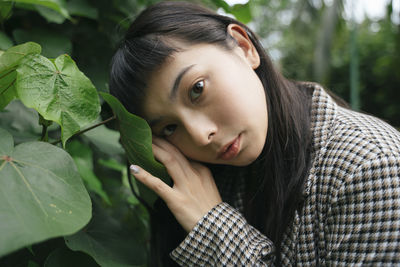 Portrait of young woman with leaves