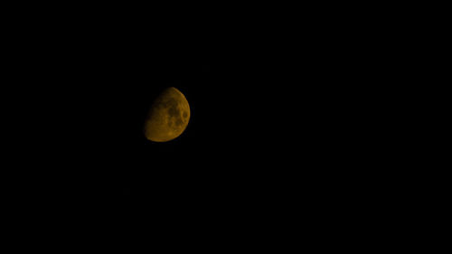 Low angle view of moon against dark sky