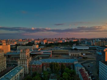 High angle view of city buildings against sky during sunset