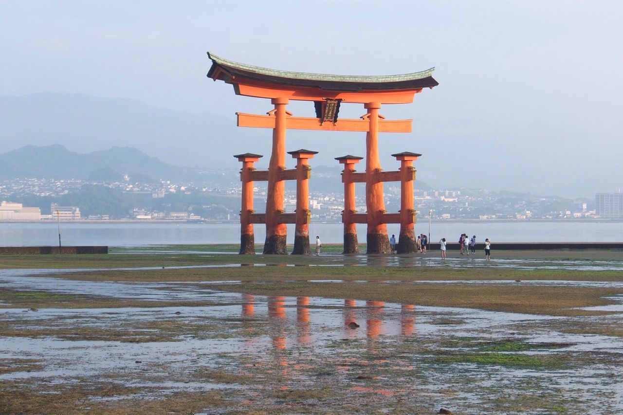 architecture, built structure, water, building exterior, sea, famous place, waterfront, sky, mountain, travel destinations, tourism, travel, international landmark, river, clear sky, history, architectural column, pier, place of worship, incidental people