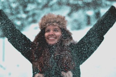 Portrait of smiling man standing on snow