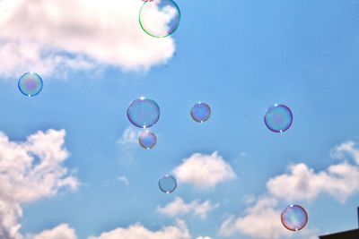 Low angle view of bubbles against sky