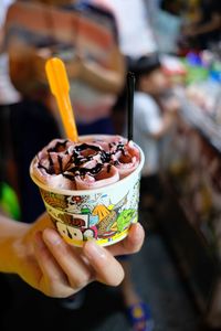 Close-up of hand holding ice cream