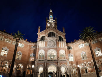 Low angle view of illuminated building against sky at night