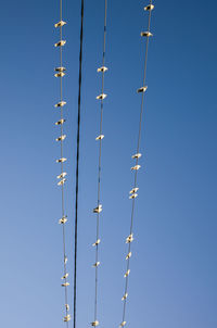 Low angle view of communications tower against clear blue sky