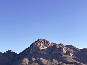 Scenic view of rocky mountains against clear blue sky