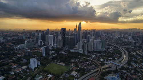 High angle view of cityscape against cloudy sky