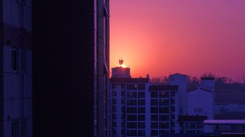 Buildings against sky during sunset