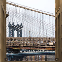 Low angle view of bridge against buildings