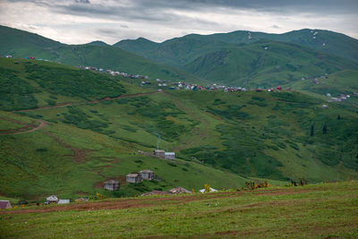 Scenic view of field and mountains against sky
