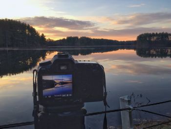 Reflection of clouds in lake against sky during sunset