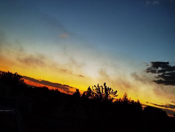 Silhouette trees against sky during sunset