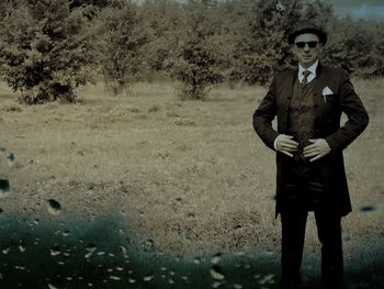 Full length portrait of young man standing outdoors