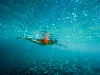 Underwater view of woman swimming in sea