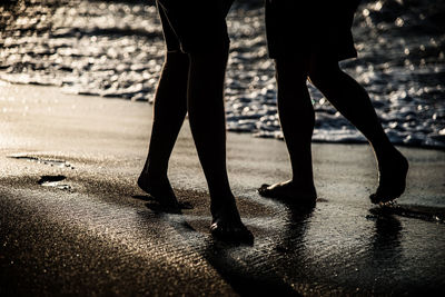 Low section of people walking on street