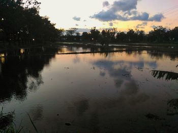 Scenic view of lake against sky at sunset