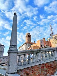 Low angle view of tower against sky in city