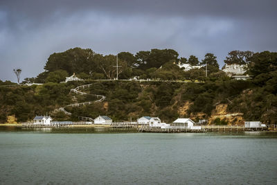 Scenic view of river by trees against sky