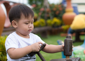 Cute boy playing outdoors in playground