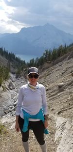 Portrait of man wearing sunglasses standing on mountain