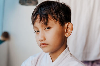 Close-up portrait of sulking boy at home